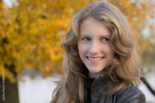 Beautiful young smiling girl outdoors