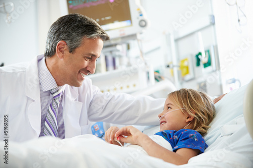 Young Girl Talking To Male Doctor In Intensive Care Unit