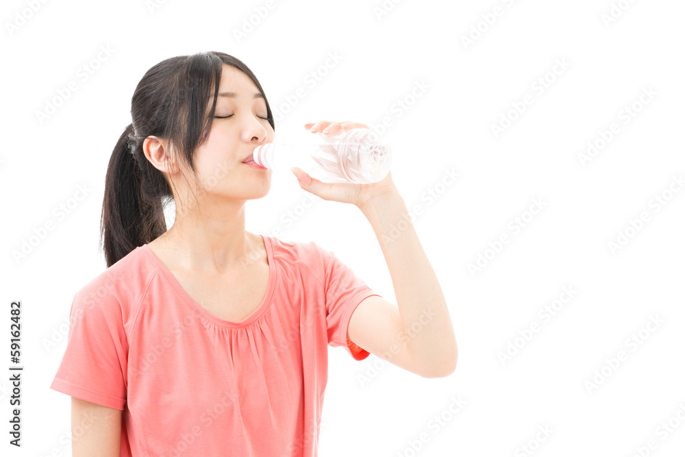 young sporty asian woman drinking water
