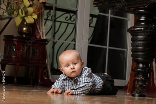 6 months male child sitting on floor