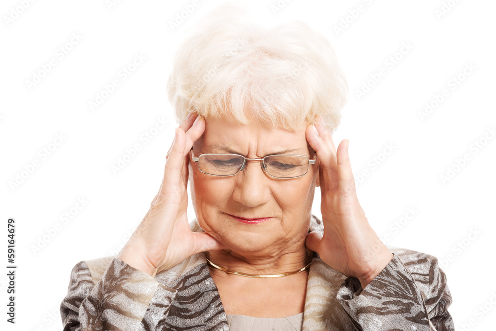 An old elegant lady is having a headache. An old elegant lady is having a headache.
