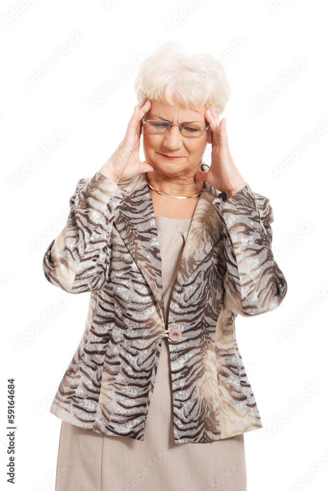 An old elegant lady is having a headache. An old elegant lady is having a headache.
