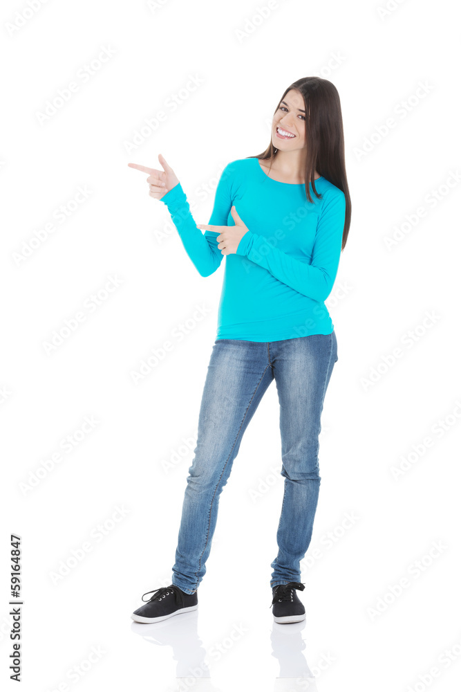 Beautiful casual woman pointing on copy space. Beautiful casual woman pointing on copy space.