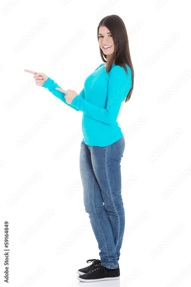 Beautiful casual woman pointing on copy space. Beautiful casual woman pointing on copy space.