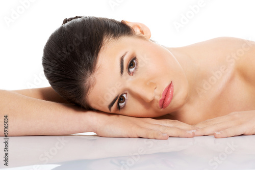 Portrait of beautiful woman lying on hands.