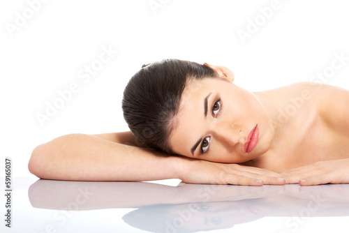Portrait of beautiful woman lying on hands.
