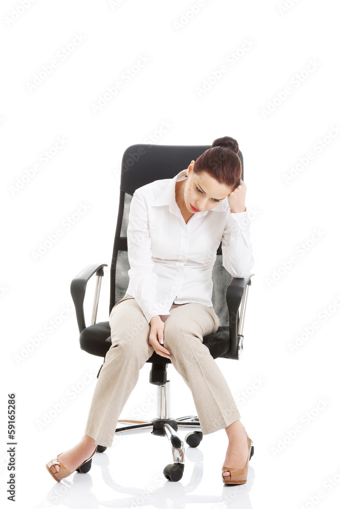 Young beautiful business woman sitting on a chair. Young beautiful business woman sitting on a chair.