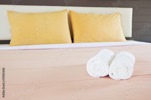Fototapeta Naklejka Na Ścianę i Meble -  style bedroom interior with White towels and double yellow pillo