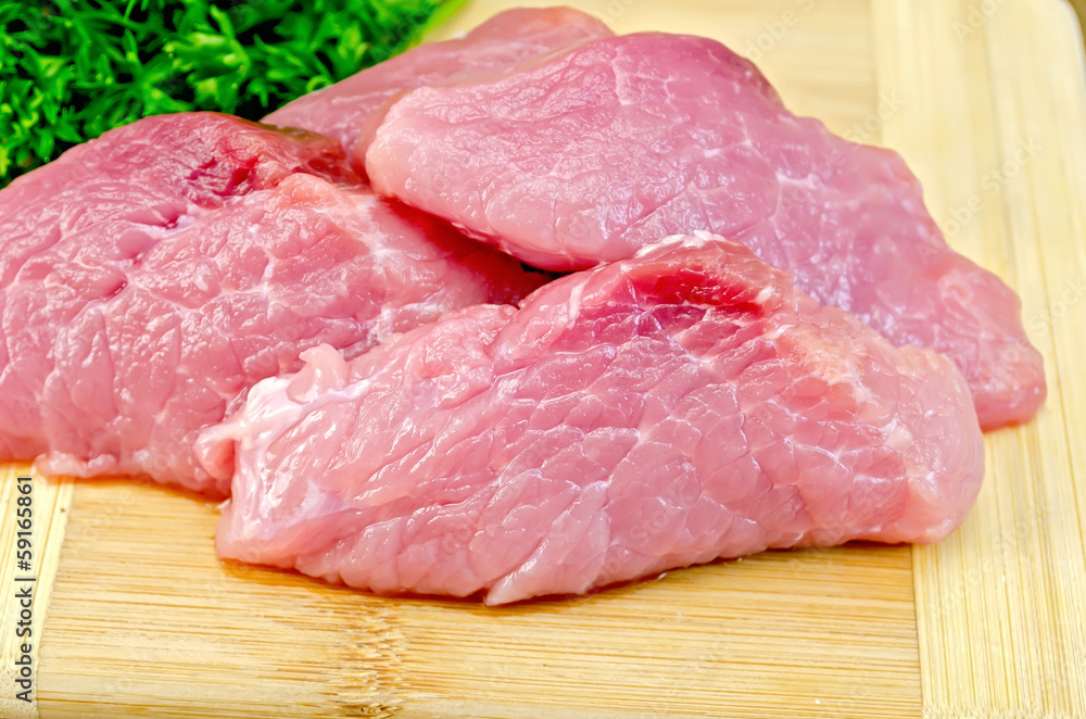 Meat pork slices on a board with spices Meat pork slices on a board with spices