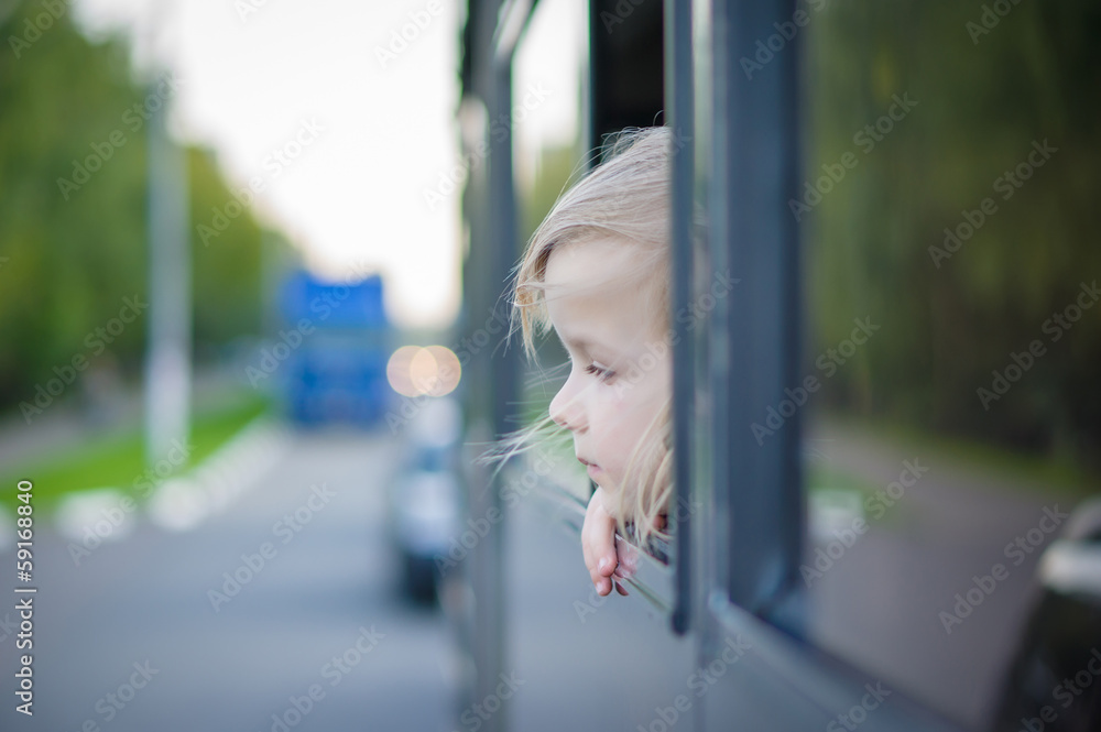 Adorable girl ride by bus and look through open window. Outside Adorable girl ride by bus and look through open window. Outside