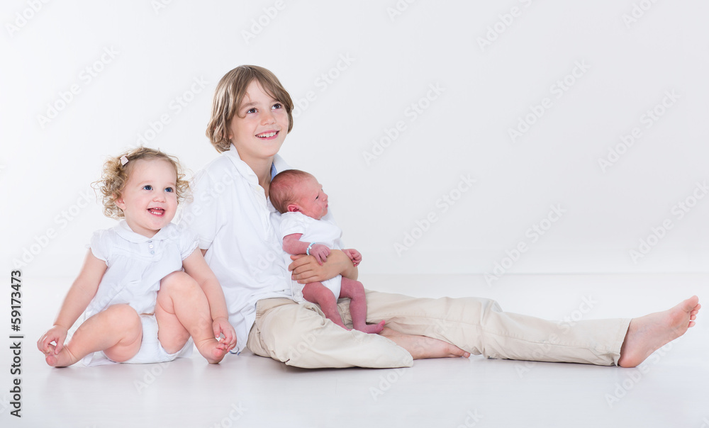 Portrait of siblings, school age boy, toddler sister and newborn Portrait of siblings, school age boy, toddler sister and newborn