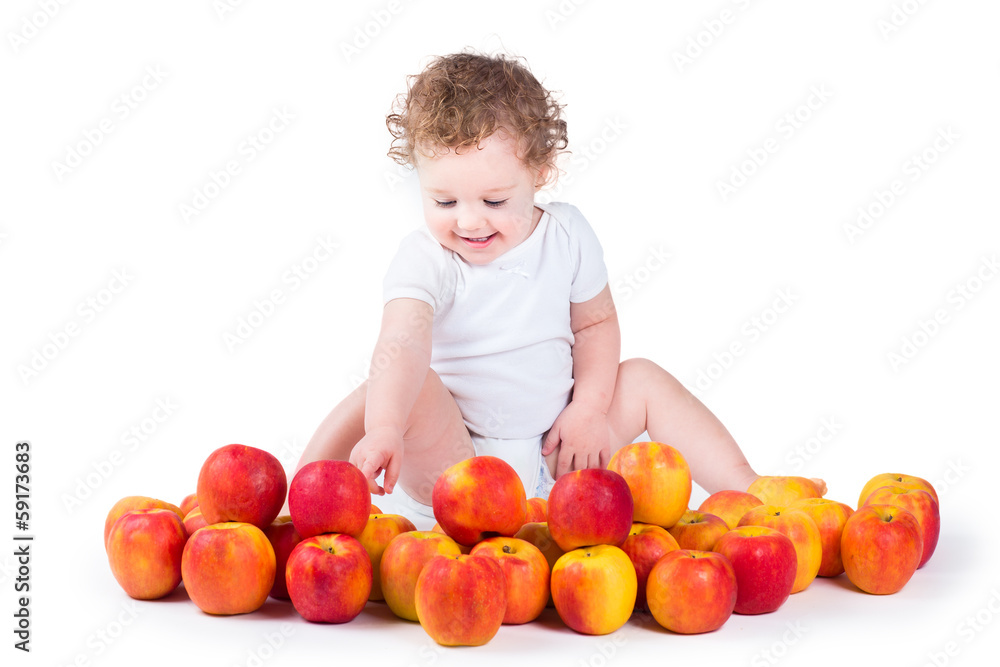 Happy laughing baby girl playing with red and yellow apples Happy laughing baby girl playing with red and yellow apples