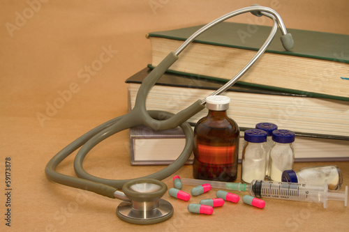 Stethoscope and medications on medical book
