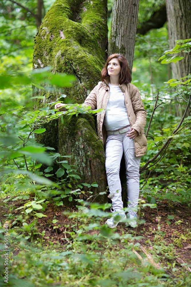 Young beautiful pregnant woman hiking in a park Young beautiful pregnant woman hiking in a park