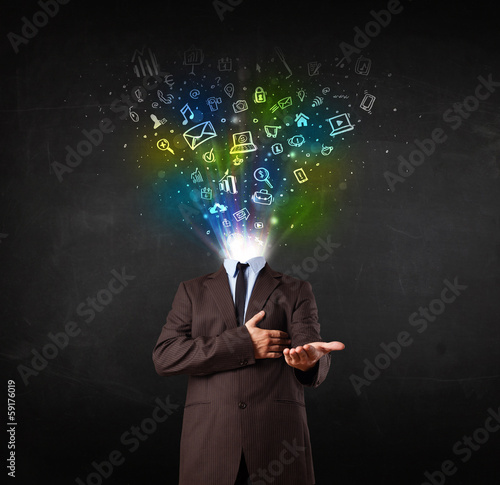 Business man with glowing media icons exploding head