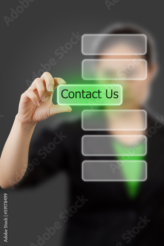 Business woman hand touching button contact us keyword.