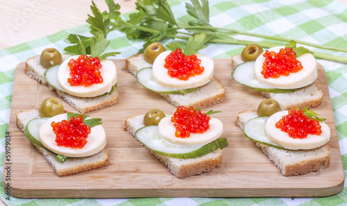 Sandwiches of white bread with salmon caviar