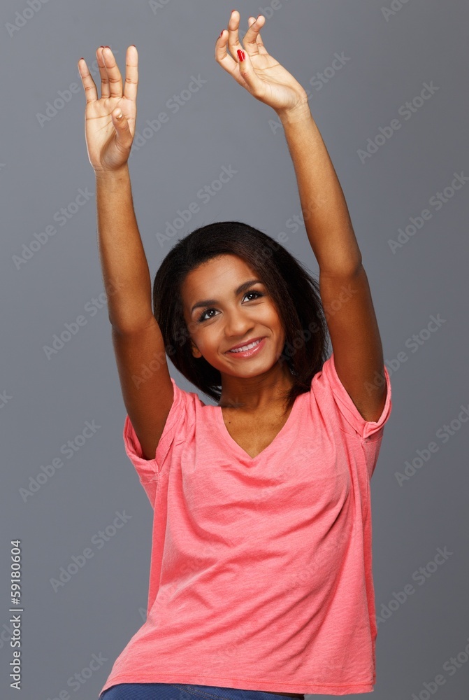 Cheerful young black woman isolated on grey background