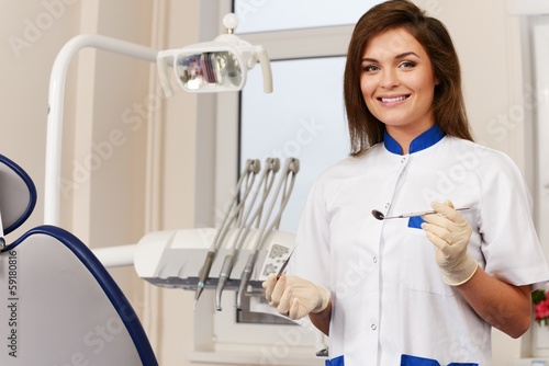 Young woman dentist with dental tools 