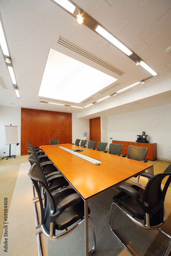 Long simple table, modern armchairs in empty room