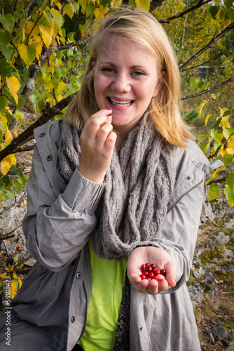 happy woman just to taste a lingonberry