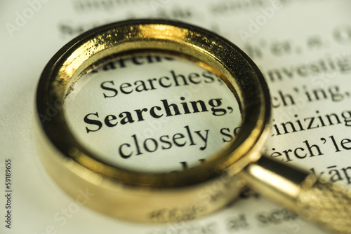 Searching Concept With Closeup Golden Magnifying Glass