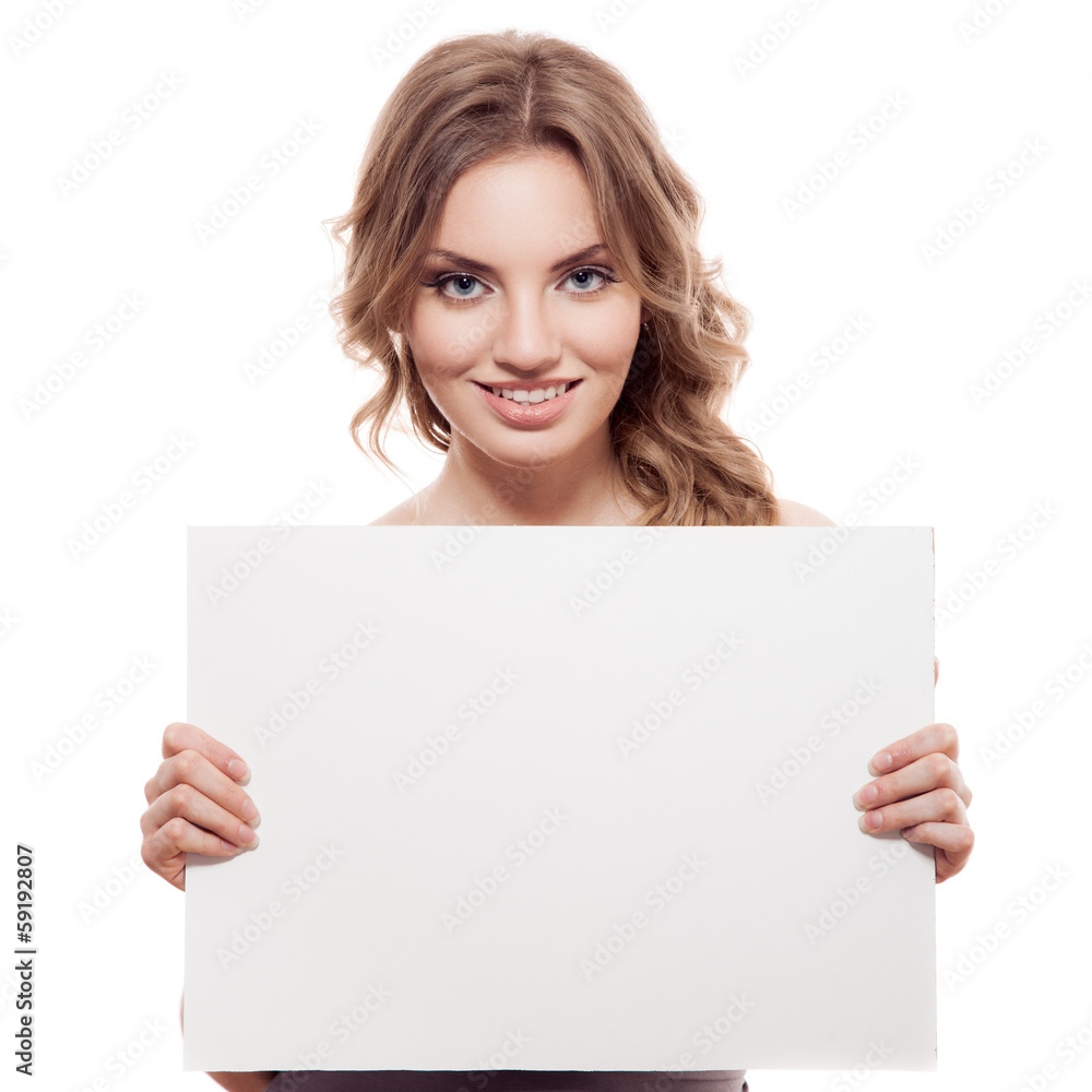 Portrait of a cheerful young blond woman holding a white blank b Portrait of a cheerful young blond woman holding a white blank b