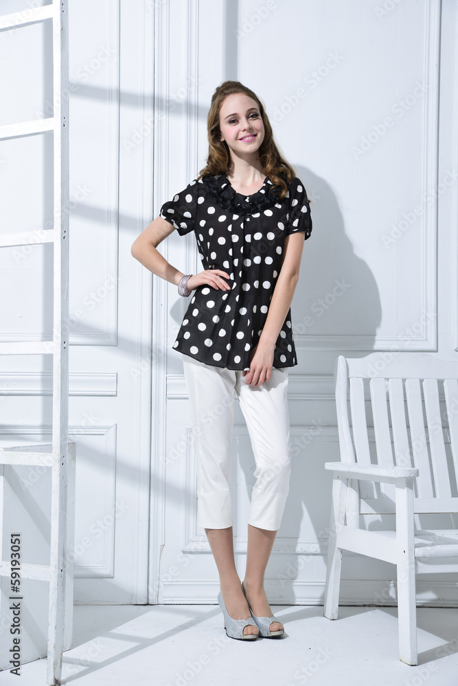 full-length portrait of fashion model with ladder, chair posing full-length portrait of fashion model with ladder, chair posing