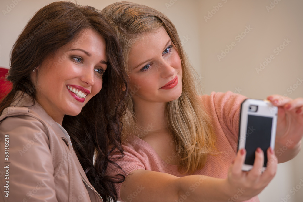 Happy girls indoors photographing while shopping Happy girls indoors photographing while shopping