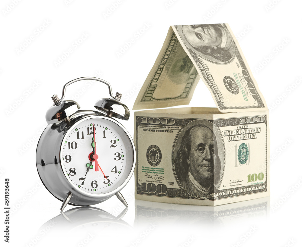 house made of dollars and alarm clock. house made of dollars and alarm clock.