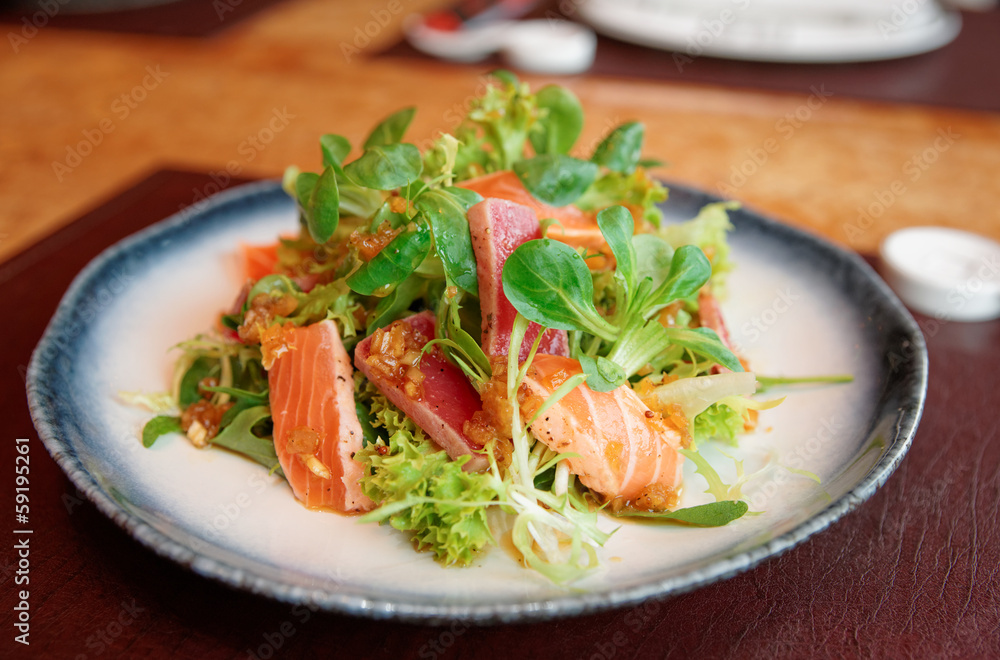 Appetizer with rare fried tuna and salmon in plate Appetizer with rare fried tuna and salmon in plate
