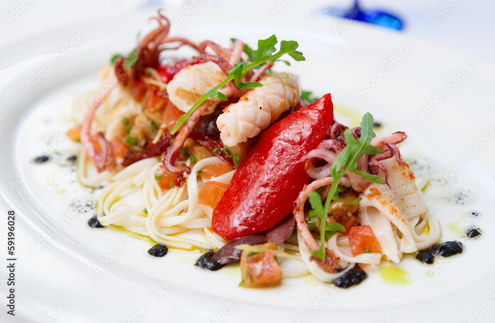 Pasta with seafood on oval porcelain plate Pasta with seafood on oval porcelain plate