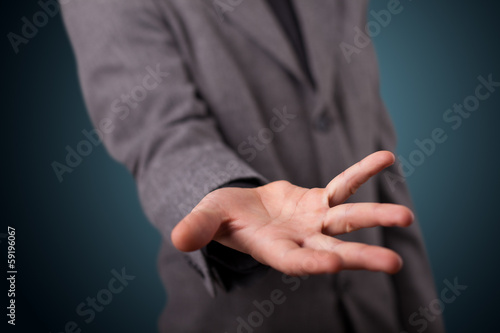 Handsome business man presenting with hand copy space