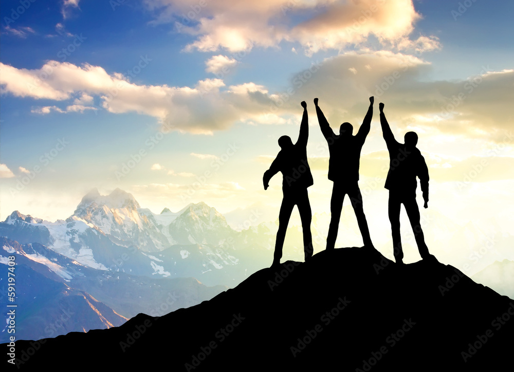 Silhouette of a team on the mountain top.