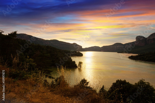 mountains lake in sunset. Sau reservoir