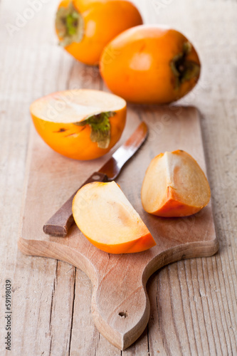ripe persimmons and knife