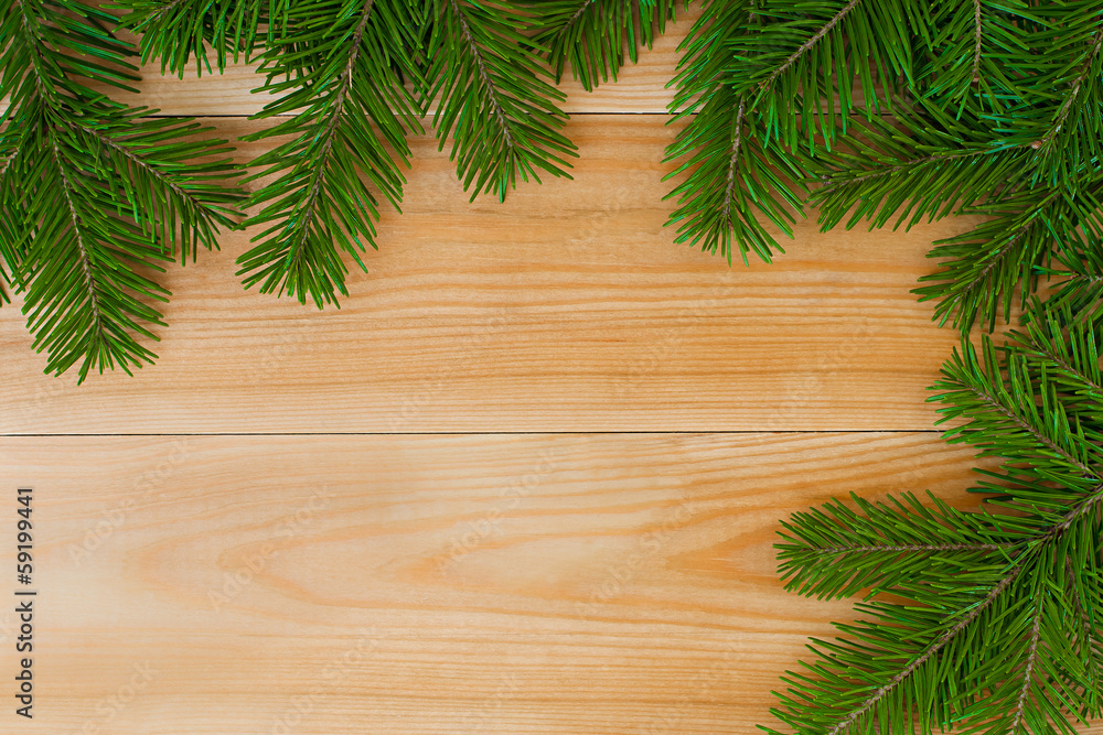 Spruce branch on a wooden background Spruce branch on a wooden background