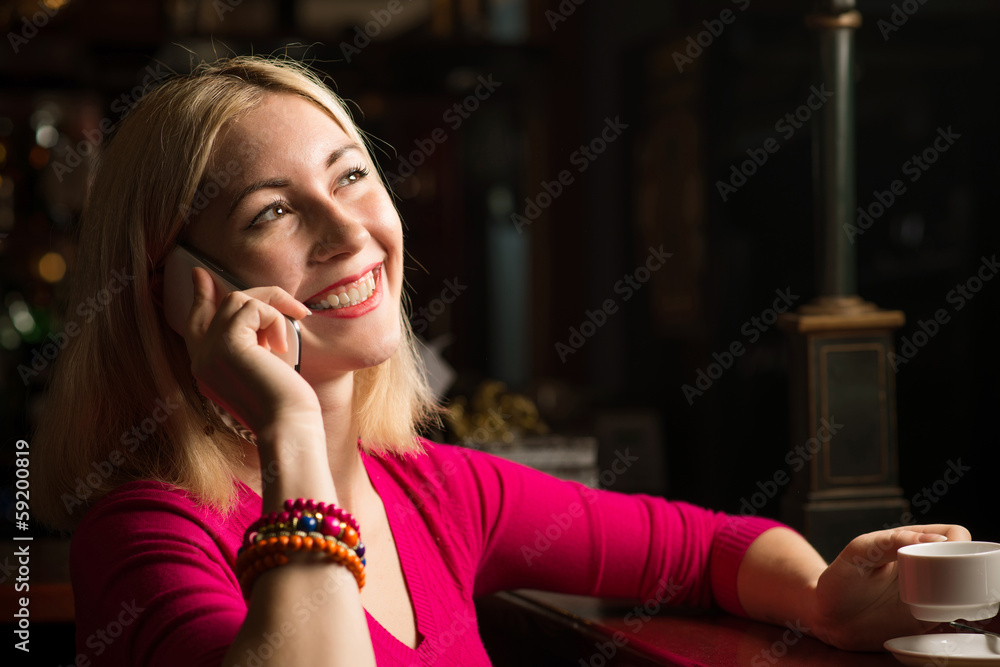woman with a cup of coffee and cell phone woman with a cup of coffee and cell phone