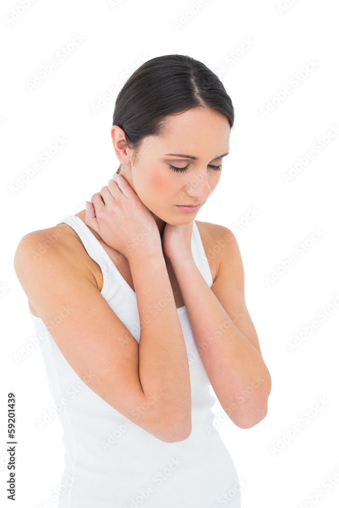 Serious casual woman suffering from neck ache Serious casual woman suffering from neck ache