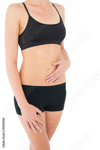 Close-up mid section of a fit woman in black sportswear © lightwavemedia