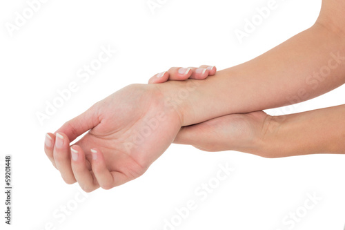 Fotografie Close-up of a young woman touching her wrist