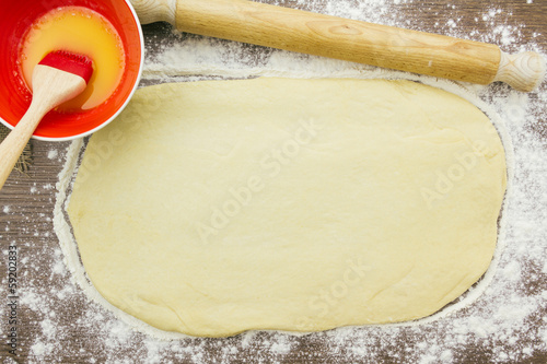 Cinnamon roll dough ready to be brushed with melted butter