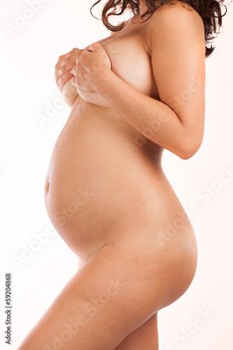 naked pregnant woman over white background