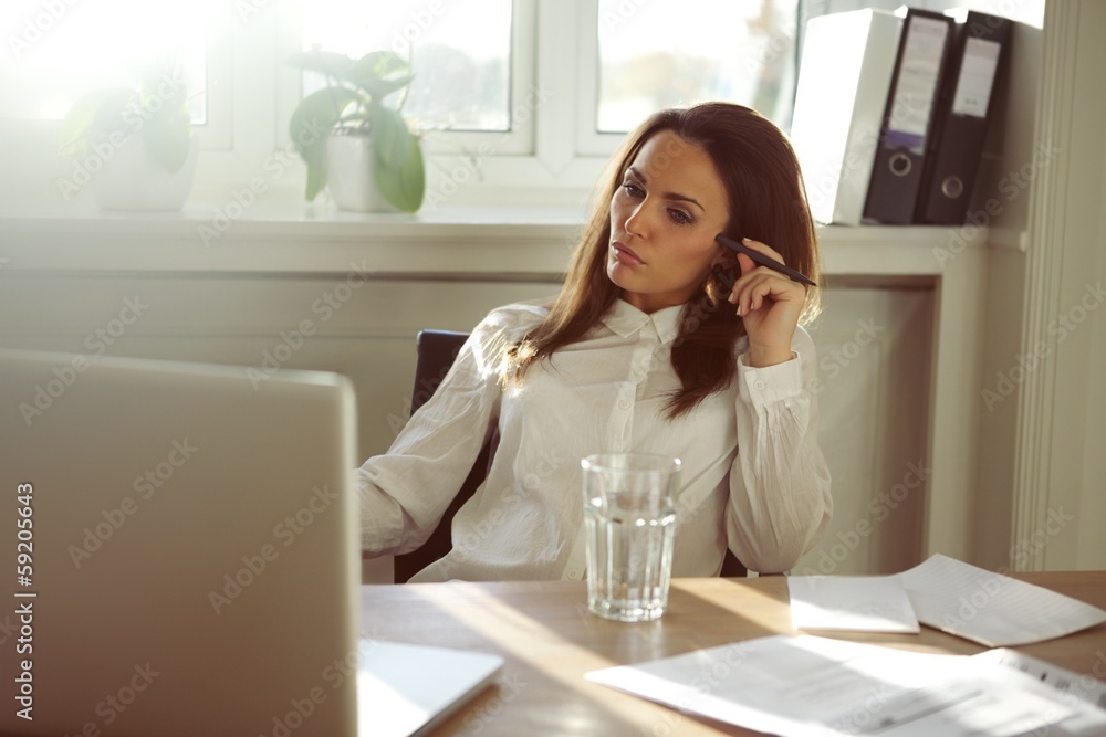 Beautiful young woman working from home Beautiful young woman working from home