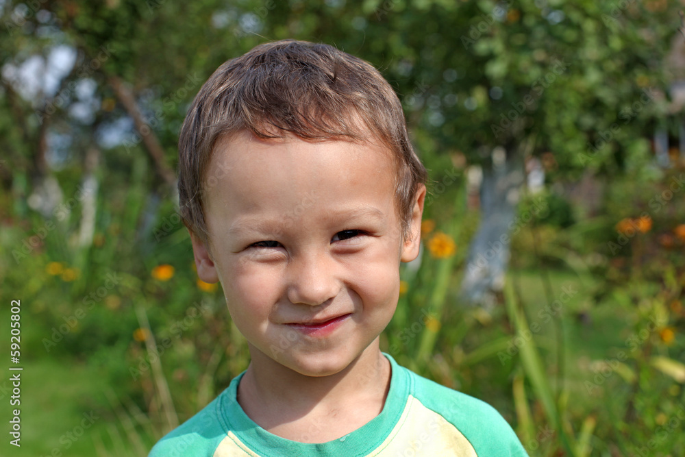 portrait of a funny little boy 3-4 year old outdoors