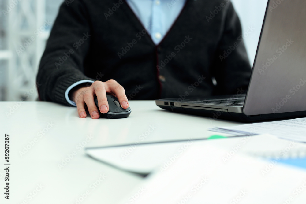 Closeup image of a casual businessman working on laptop Closeup image of a casual businessman working on laptop