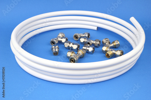 The pex pipe and armature on the blue background