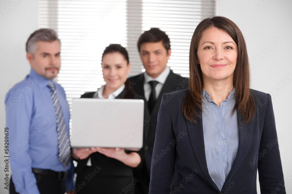 Successful smiling middle age woman looking at camera. Successful smiling middle age woman looking at camera.