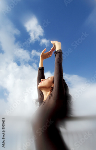 Beautiful Young Woman over blue Sky photo