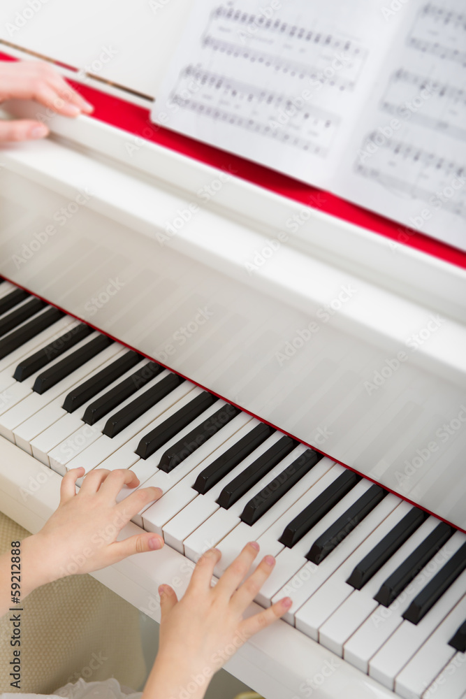 Fototapeta premium Close up of hands playing piano